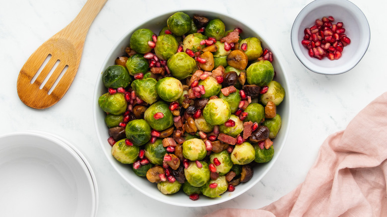 Brussels sprout dish in bowl with pomegranate seeds