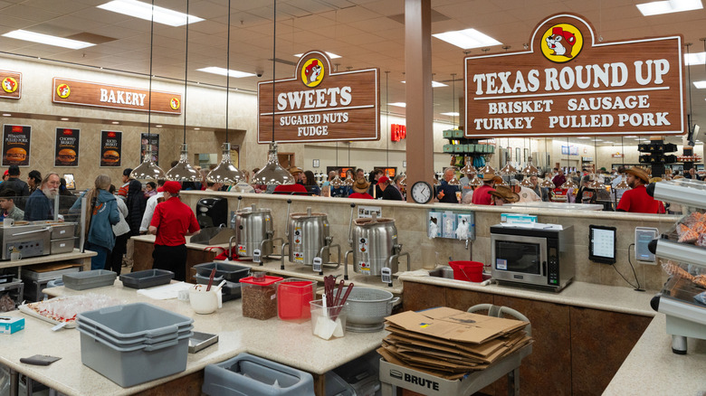 The inside of a Buc-ee's store with shoppers walking around.