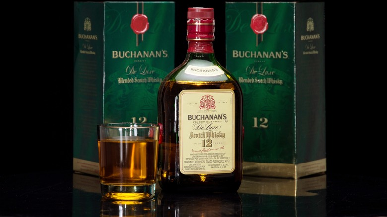 Buchanan's !2 Year Scotch bottle and glass in front of two packaging boxes 