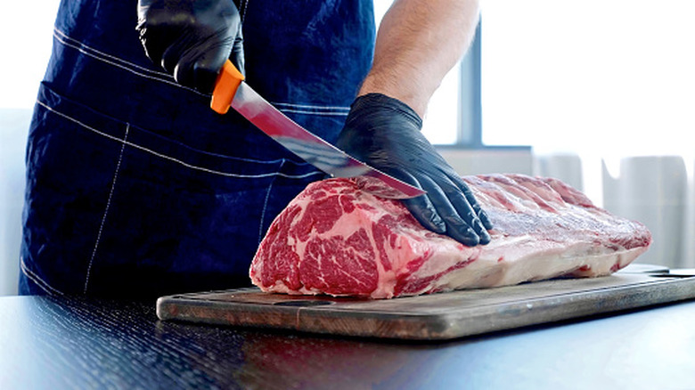 Butcher cutting meat