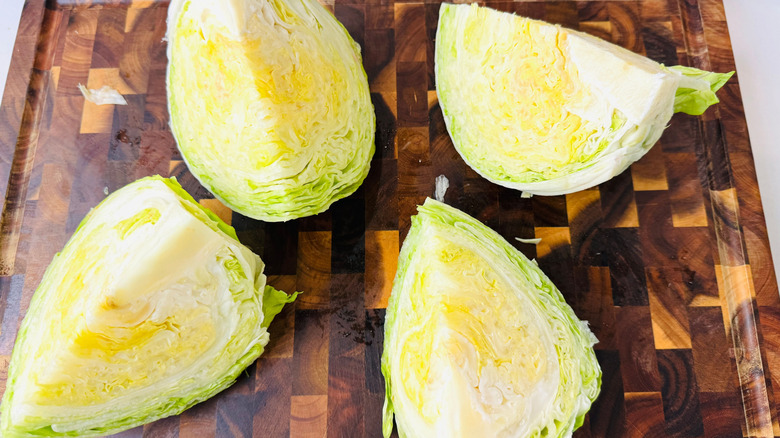 Iceberg lettuce quarters on wooden board