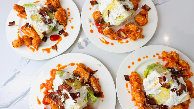 Buffalo chicken wedge salads on plates