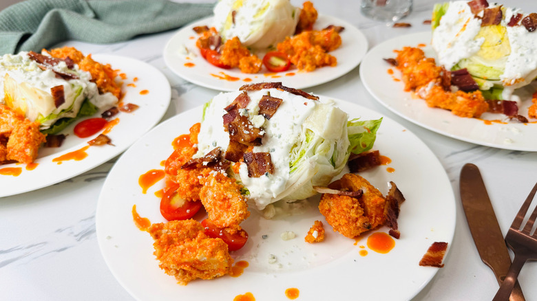 Buffalo chicken wedge salads on plates
