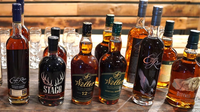 A selection of different Buffalo Trace bourbons with tasting glasses in the background.
