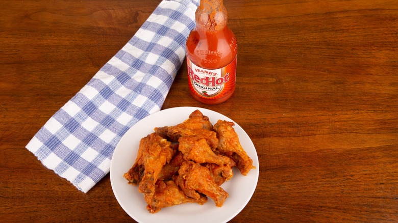 Frank's RedHot sauce and pile of chicken wings