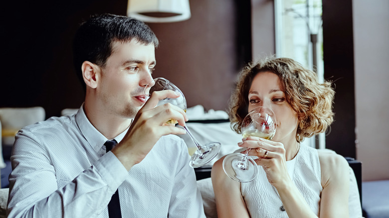 Couple sipping wine on date