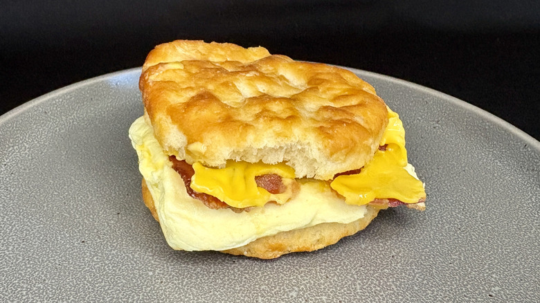 Bacon, egg, and cheese biscuit on gray plate