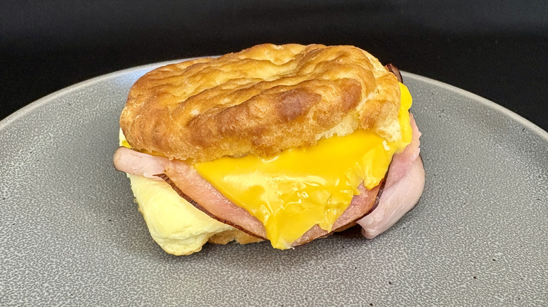 Ham, egg, and cheese biscuit sandwich on gray plate
