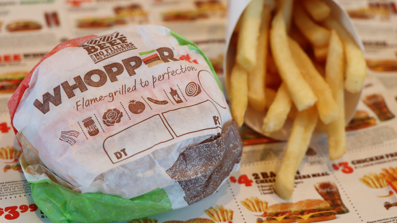 A wrapped BK whopper with fries 