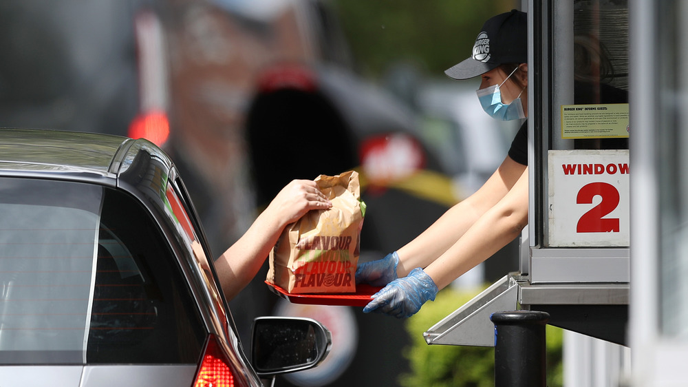 Woman working at Burger King drive-thru