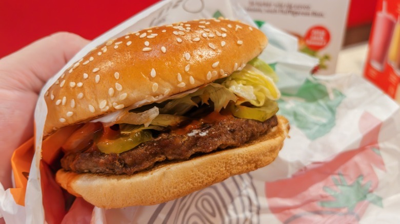 Hand holding a Burger King Whopper