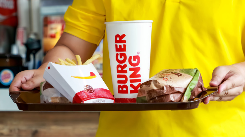 burger king employee holding meal