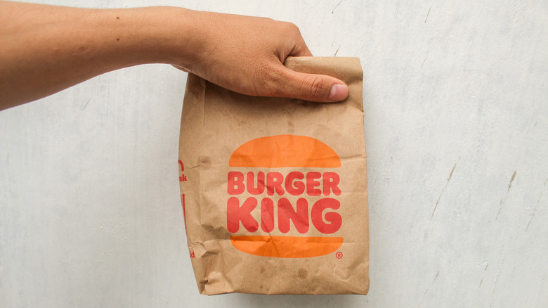 Customer holding a Burger King bag