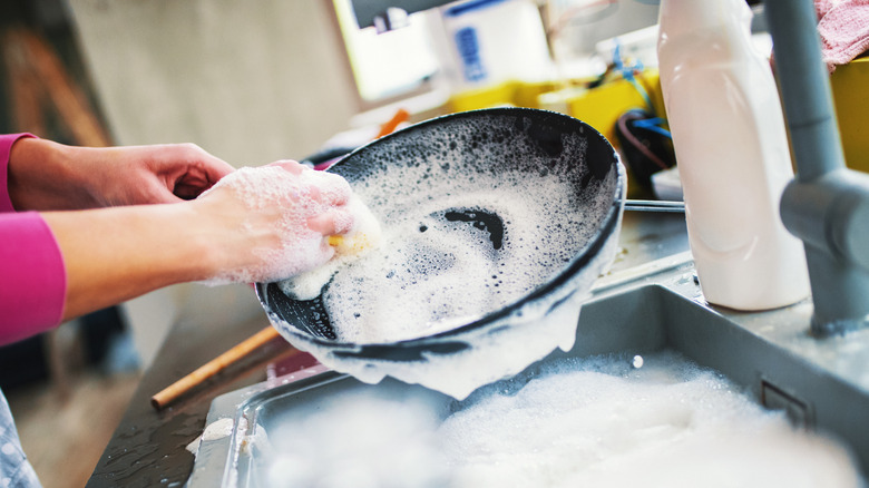 Person scrubbing pan