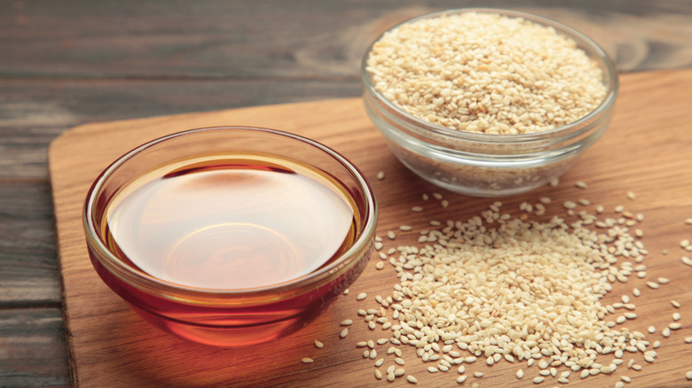 Bowls of sesame oil and seeds