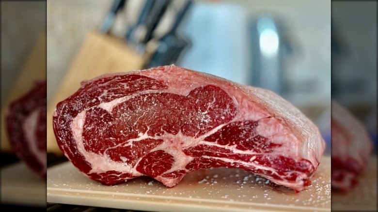 Uncooked prime rib roast with intact fat cap