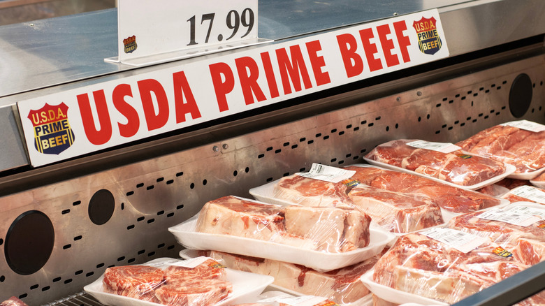 USDA prime beef in freezer case under signage