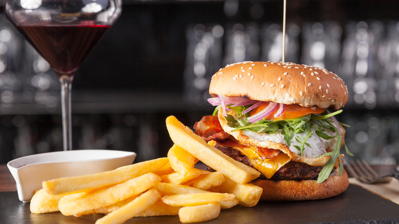 Cheeseburger and red wine glass