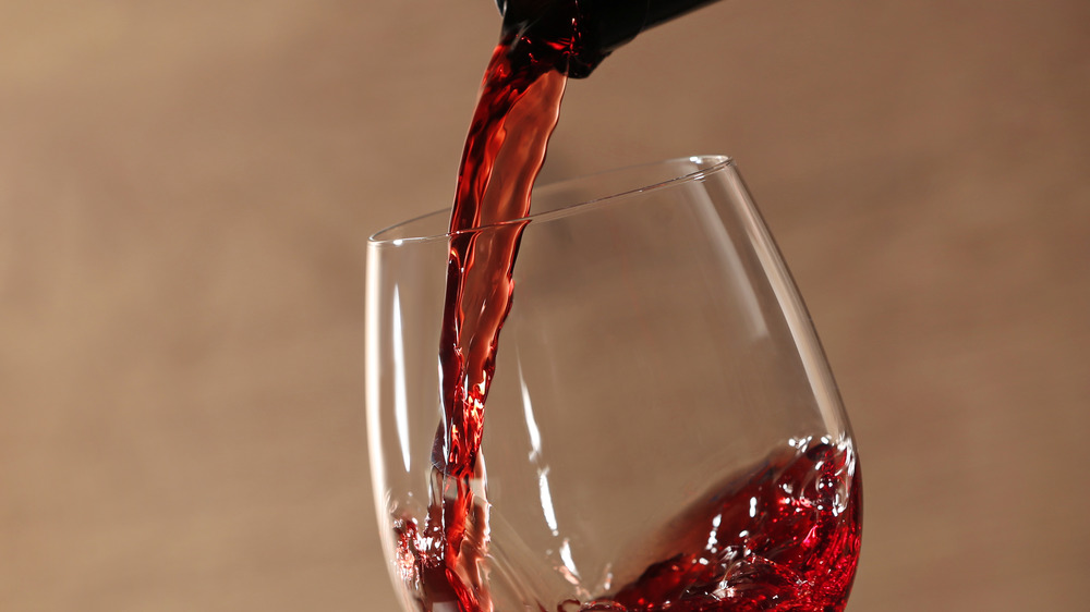 red wine pouring into glass