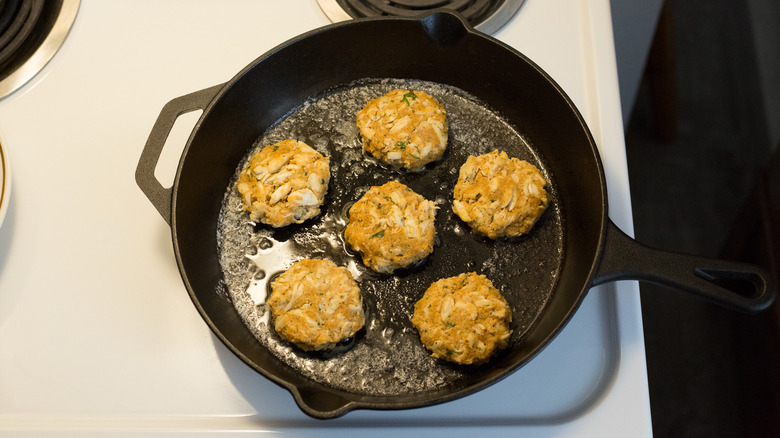 crab cakes in frying pan