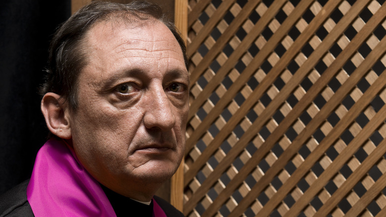 priest in a confession booth