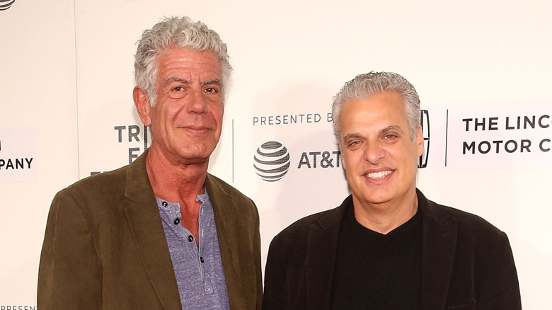 Anthony Bourdain and Eric Ripert posing with AT&T backdrop