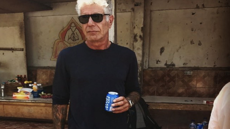 Anthony Bourdain with sunglasses holding a can