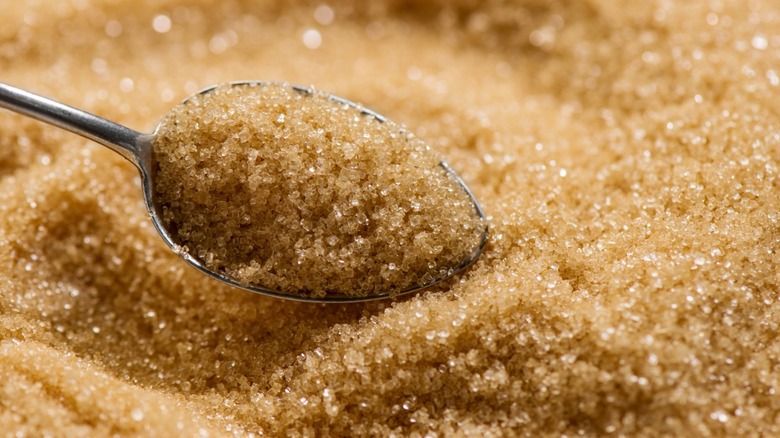 Brown sugar being scooped by a spoon