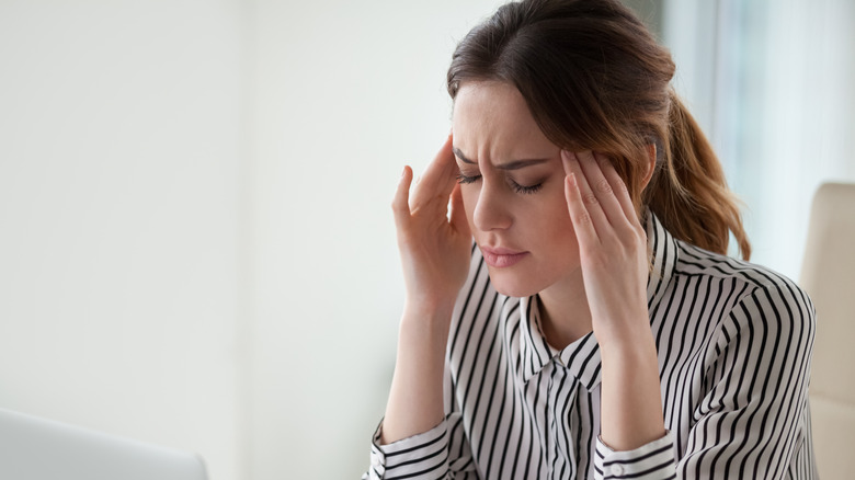 Woman suffering from migraine headache
