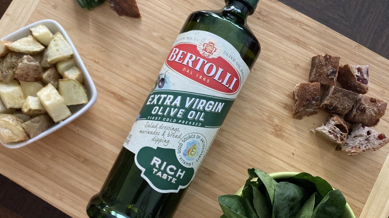 Bertolli olive oil on cutting board