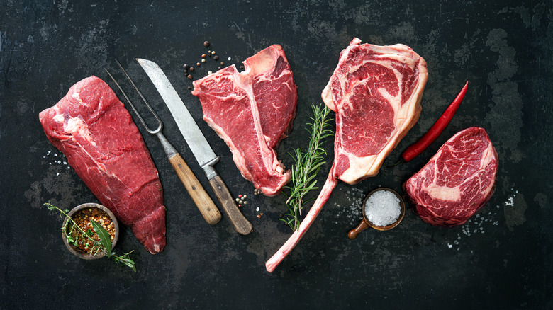 Raw meat with seasonings, knife