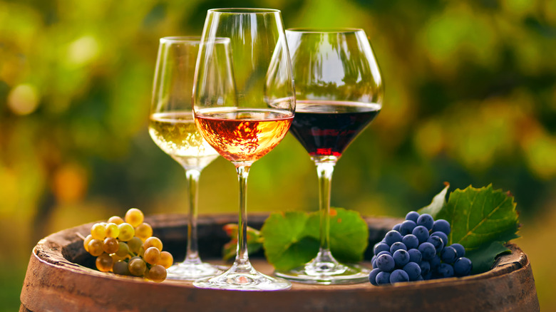 Three glasses of wine on a barrel