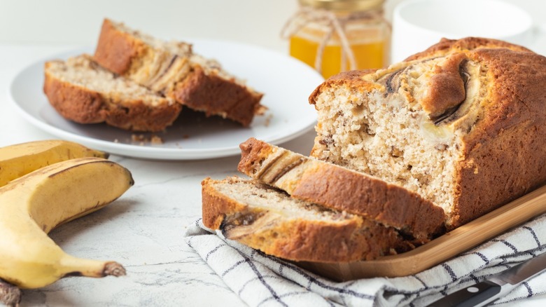 Banana bread sliced on a wooden tray 