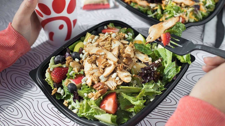 person eating Chick-fil-A salad