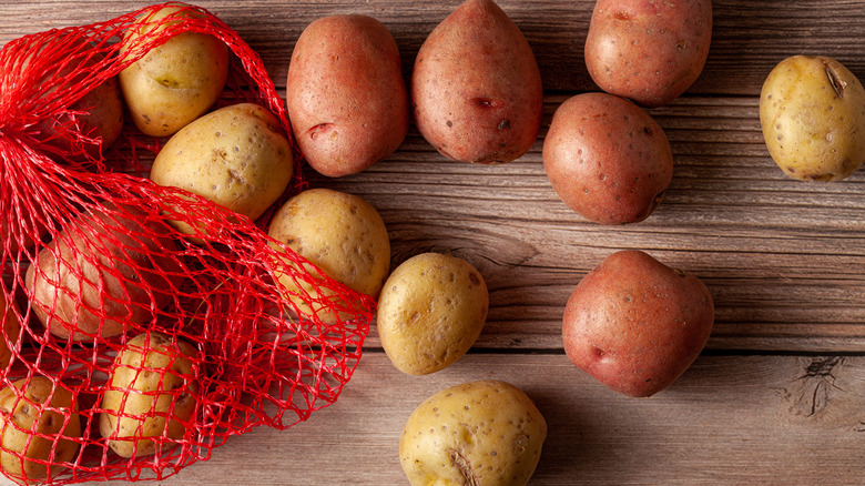 Potatoes spilling out of a mesh bag 