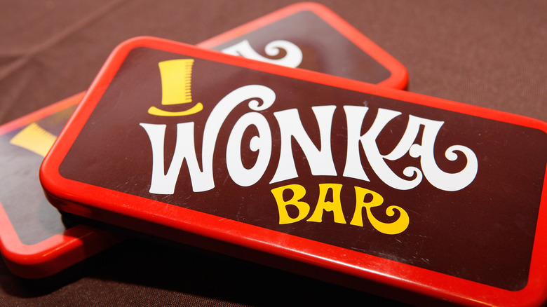 Plastic Wonka chocolate bars on brown wood