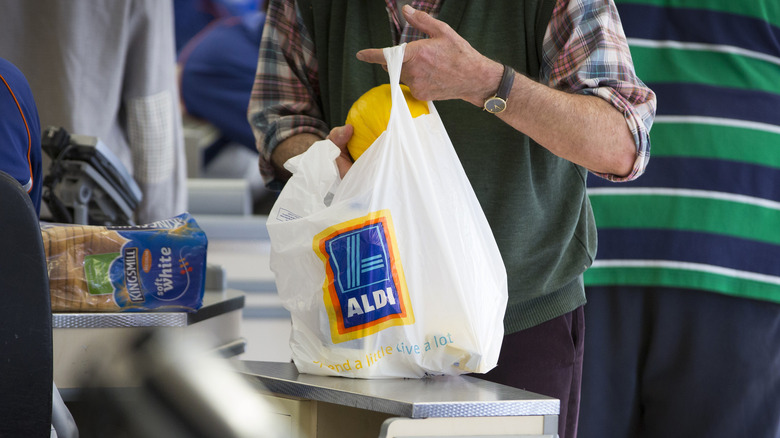 Customer bagging Aldi groceries