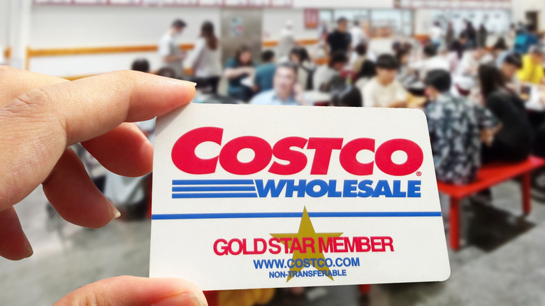 Costco membership card being held near food court.