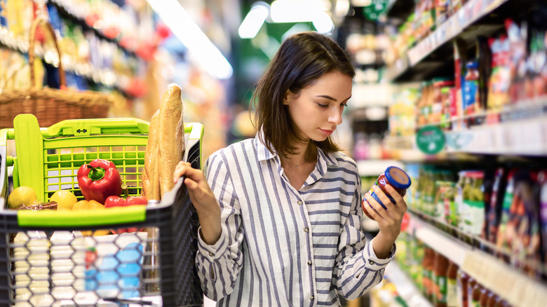 Woman grocery shopping with cart