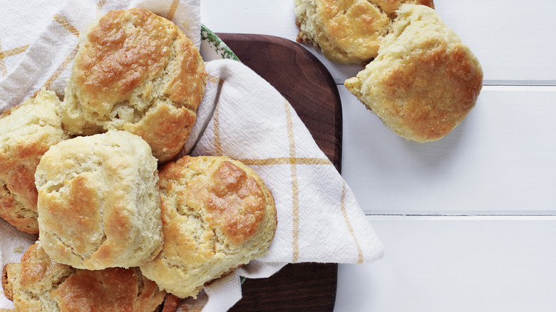 a bowl of biscuits with a towel on a table