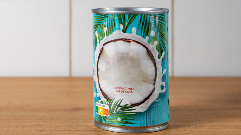 Can of coconut milk on wooden counter