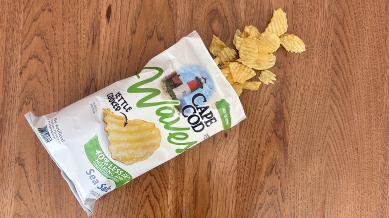 bag of rippled chips open and spilling on table