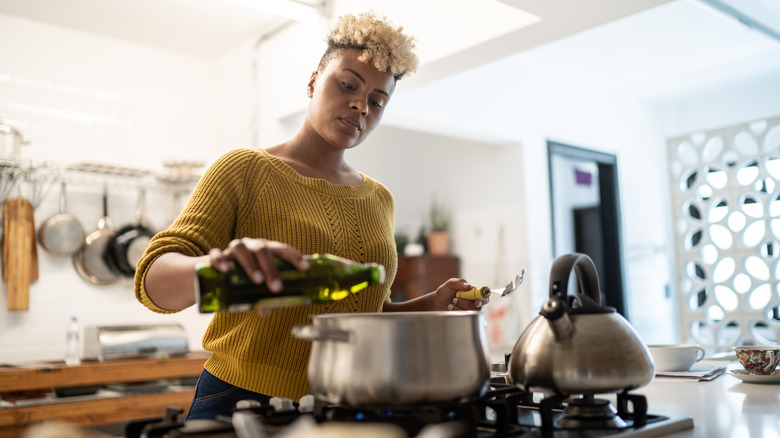 Woman cooking on stove