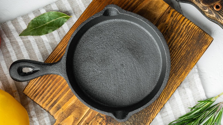 Cast iron pan on a wooden cutting board