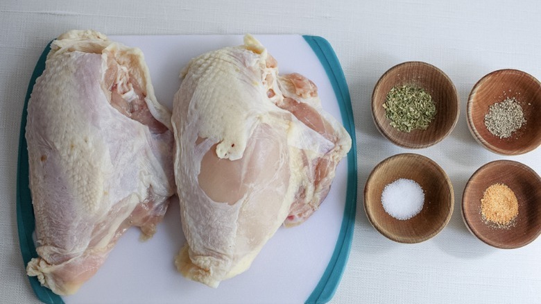 seasoning next to chicken breasts