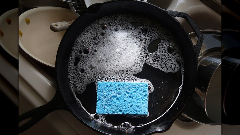 washing skillet in sink