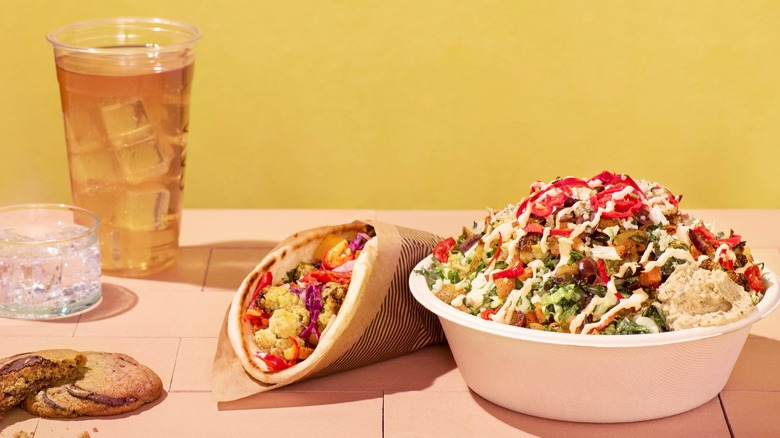 A drink, cookie, pita wrap, and vegetable bowl from Cava