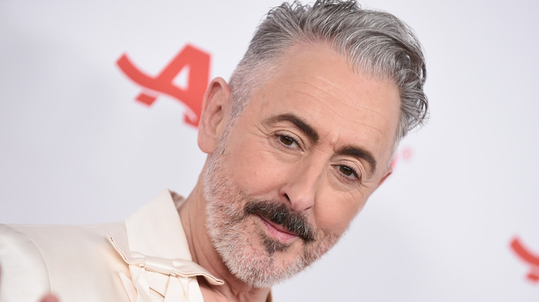 Alan Cumming against white backdrop