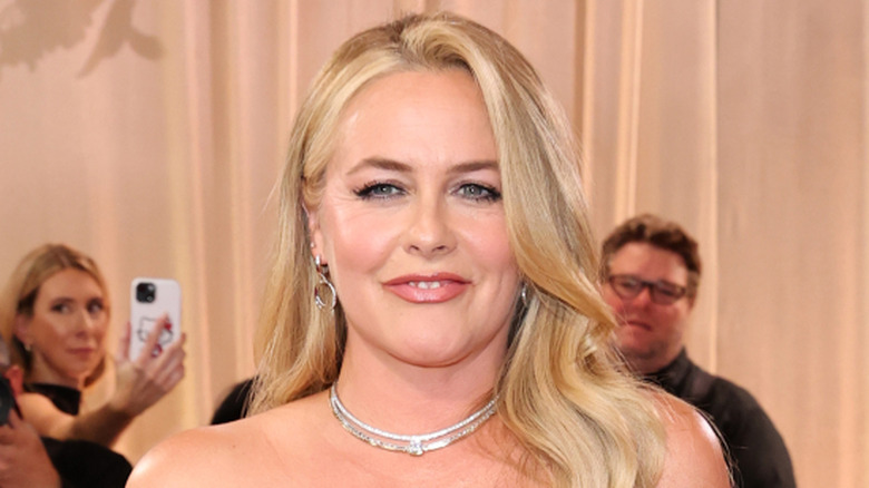 Alicia Silverstone poses at event wearing diamond necklace