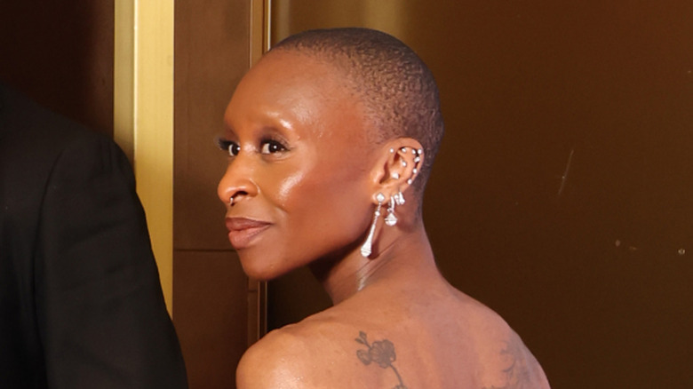 Actress and singer Cynthia Erivo smiles over her shoulder